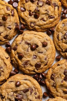 chocolate chip cookies are arranged on a white surface