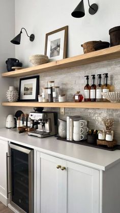 a kitchen with shelves filled with bottles and jars on top of it's counters