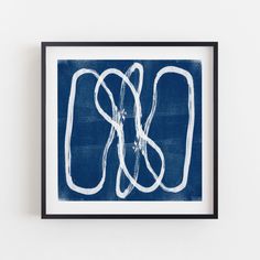 a framed blue and white print with the letter s in it's lower half