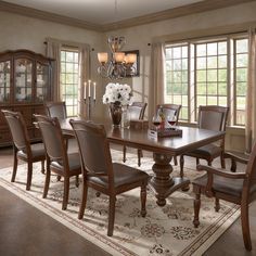 a dining room table with chairs and a chandelier