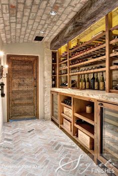 a wine cellar with wooden shelves filled with bottles