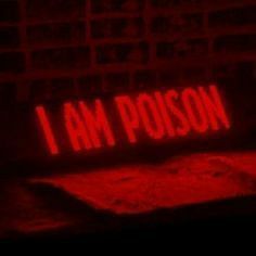 a red neon sign that says i am poison