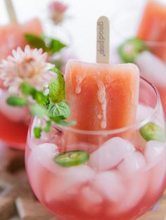 two glasses filled with ice and watermelon slices on top of eachother