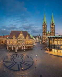 an old building with two towers and a sundiall in the middle of it