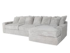 a large white couch with lots of pillows on it