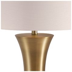 a gold table lamp with a white shade on the top and bottom part of it