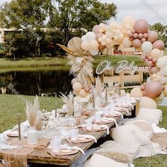 a table set up with balloons and plates