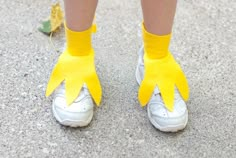 a person wearing yellow gloves and white shoes