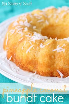 a close up of a bundt cake on a plate with coconut sprinkles