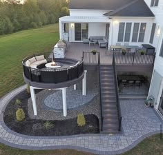 an aerial view of a house with a patio and fire pit in the middle of it