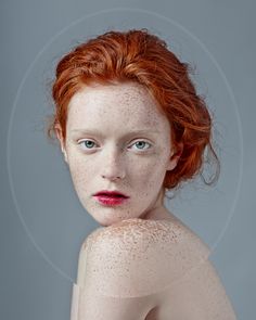 a red headed woman with freckles on her body