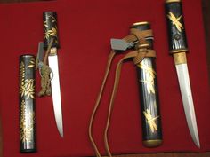 four different types of knifes on a red surface with gold leaf designs and dragon handles