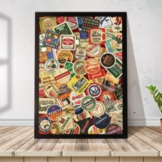 a poster with many different types of beer bottle caps on it in a room next to a potted plant