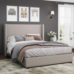 a bedroom with gray walls and white carpeted flooring, a large bed has two framed pictures on the wall above it