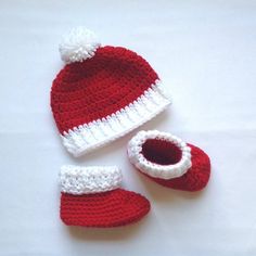 a crocheted hat and booties are laying on a white surface