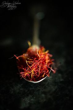 a small metal bowl filled with red and yellow cranberry sprinkles