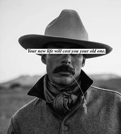 a man wearing a hat with the words you're new life will cost your old one