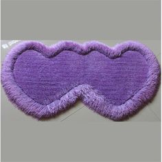 a purple heart shaped rug on top of a table