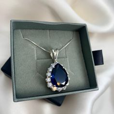 Princess Diana Necklace set with a Created Sapphire in a perfect diamond cut, flawless clarity & royal blue color, at size 16x12mm (9 Cts). Surrounded by top grade CZ DiamondsSolid 925 Sterling Silver ☞ made to last.Click here for ☞ Matching RingClick here for ☞ Matching EarringsDetails:• Created Sapphire & CZ Diamonds in a flawless clarity • Sapphire: 16x12mm, 9 Cts, diamond cut• Diamonds: 3mm each, 1.5 Ct combined, diamond cut• Pendant Height 24mm, Width 24mm• Free Complimentary Chain• Solid 9 Diana Necklace, Blue Sapphire Pendant, Blue Bridal, Blue Pendant, Sapphire Pendant, Royal Blue Color, Cz Diamond, Bridal Necklace, Princess Diana