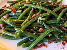 green beans with bacon and seasoning on a white plate