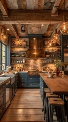 a large kitchen with wooden floors and lots of counter space, lights hanging from the ceiling