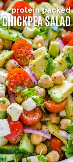 a salad with chickpea, tomatoes and cucumber in it is shown