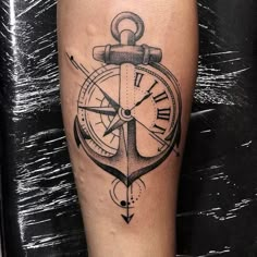 an anchor and compass tattoo on the right leg, which is drawn in black ink