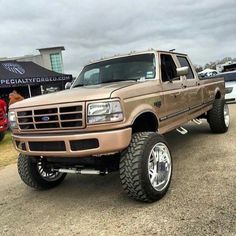 a brown truck parked on top of a parking lot