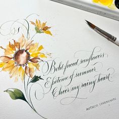 watercolors and ink are being used to create an art piece with flowers on it