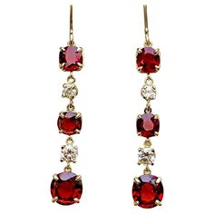 Ultra fine unheated Burma Red Spinel and Diamond Drop Earrings in 18K Yellow Gold. The cushion cut red spinel pair on bottom weigh a total of 3.02 carats and the four antique cushion cut spinel on the top weigh a total of 3.05 carats. The four round cut diamonds weigh a total 0.72 carats, G-H in color and VS in clarity. These magnificent earrings are 2 inch in length. Total Gemstone Weight: 6.79 carats Notice that all items manufactured by us can be customized or redesigned. Luxury Red Earrings For Formal Occasions, Classic Red Earrings For Evening, Formal Red Earrings With Prong Setting, Formal Red Ruby Earrings, Red Diamond Gemstone Earrings, Red Hallmarked Evening Jewelry, Luxury Ruby Dangle Jewelry, Classic Red Ruby Earrings, Classic Ruby Red Earrings