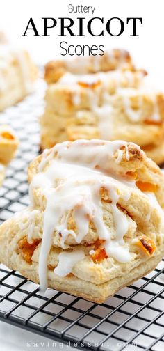 buttery apricot scones with white icing on a wire cooling rack