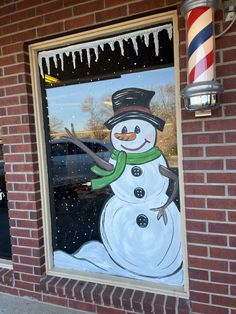 a window with a snowman painted on it