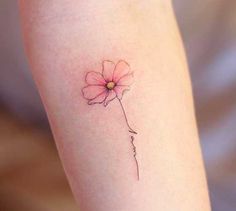 a single flower tattoo on the left arm is shown in black ink, and it has a small pink flower with a yellow center