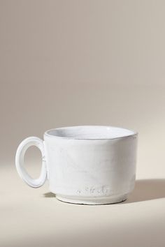 a white cup sitting on top of a table