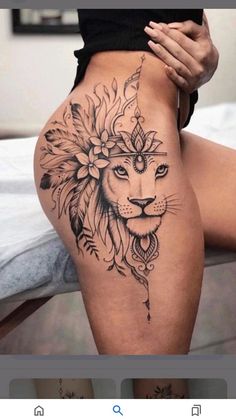 a woman's thigh with a lion tattoo on it and an arrow in the middle