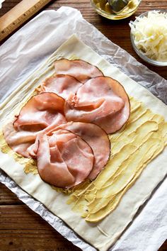 some food is laying on top of wax paper and ready to be put in the oven