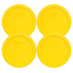 four yellow frisbees sitting on top of each other