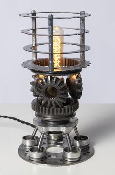 a light that is sitting on top of a metal object with gears and wheels around it