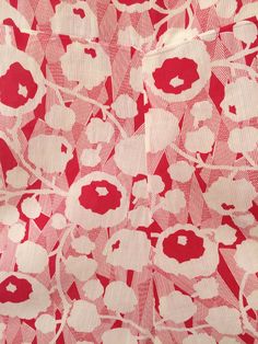 red and white fabric with flowers on it