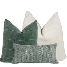 two green and white pillows sitting next to each other