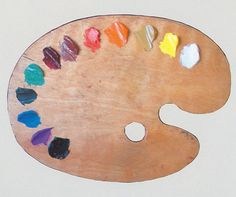 a wooden palette with colored crayons on it