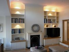 a living room filled with furniture and a fire place in front of a flat screen tv