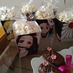 there are many bags of popcorn on the table with one bag full of chocolate covered doughnuts