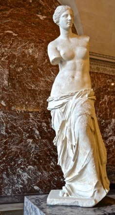 a marble statue in the middle of a room