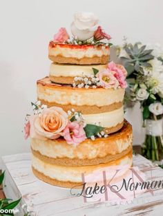 a three tiered cake with flowers on top