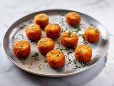 small appetizers are arranged on a plate with parsley sprinkles