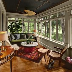 a living room filled with furniture and lots of windows