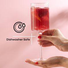 two hands holding a wine glass with red liquid and the words dishwasher safe