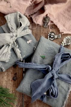 two pieces of cloth tied together on top of a wooden table next to a pine tree