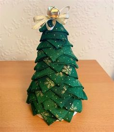 a small green christmas tree on top of a wooden table